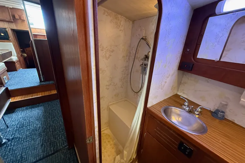 Slide: The Image of 1974 Spencer 53 yacht interior with bathroom, shower, and sink. - 24