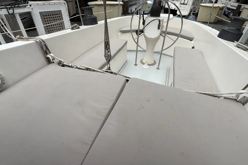 Slide: The Image of 1974 Spencer 53 sailboat cockpit with cushioned seating and steering wheel. - 6