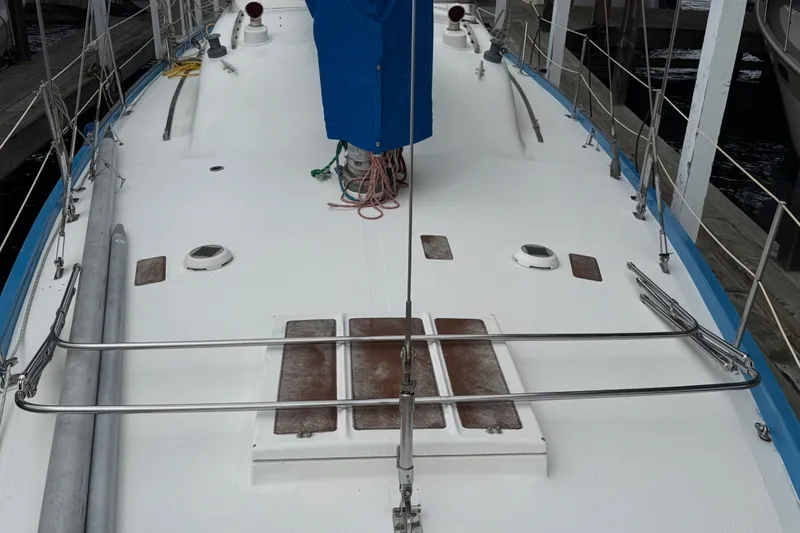 Slide: The Image of Deck of a 1974 Spencer 53 sailboat with blue accents and metal railings. - 59