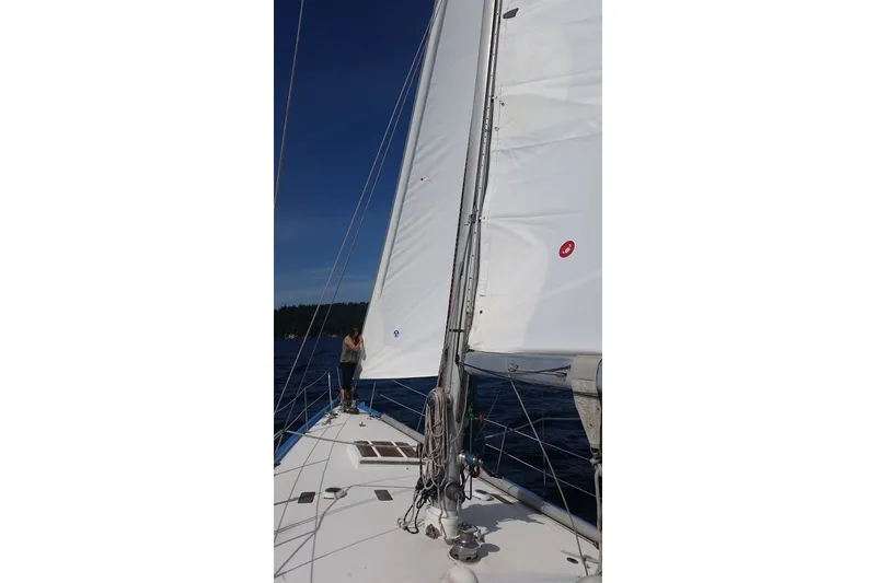 Slide: The Image of Sailing on a 1974 Spencer 53 yacht with white sails against a clear blue sky. - 67