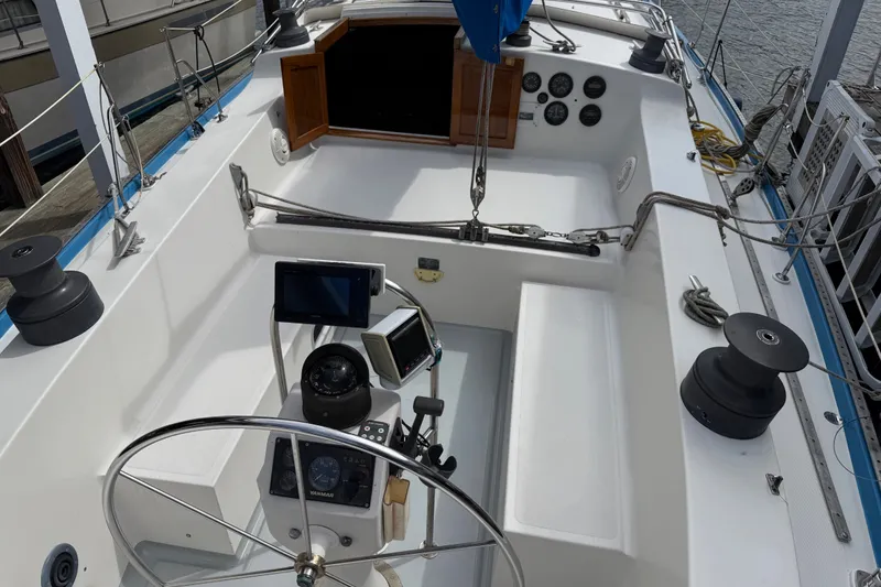Slide: The Image of Cockpit of a 1974 Spencer 53 sailboat with navigation instruments and steering wheel. - 4