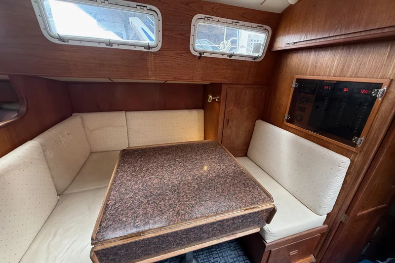 Slide: The Image of 1974 Spencer 53 yacht interior with wood paneling and cushioned seating area. - 42