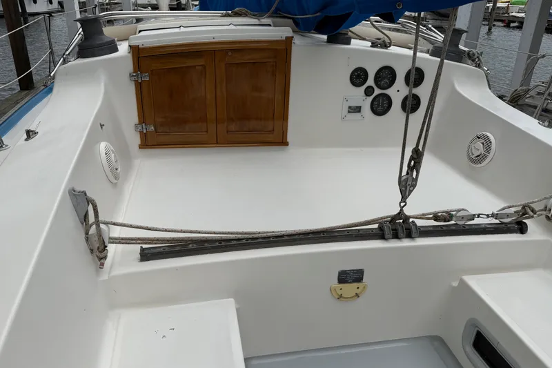 Slide: The Image of Cockpit of a 1974 Spencer 53 sailboat with wooden cabinet and nautical instruments. - 56