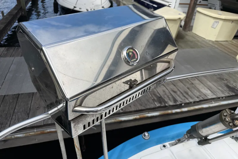 Slide: The Image of Stainless steel grill on a Spencer 53 boat, docked by the water. - 45