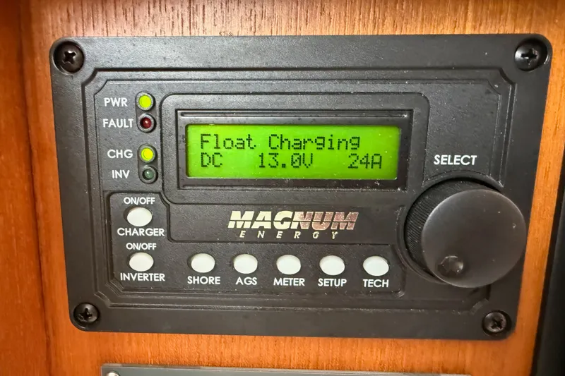 Slide: The Image of Magnum Energy control panel displaying float charging at 13.0V and 24A on a Spencer 53. - 51
