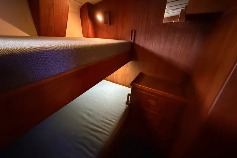 Slide: The Image of Cozy wooden bunk beds in a 1974 Spencer 53 yacht cabin. - 22