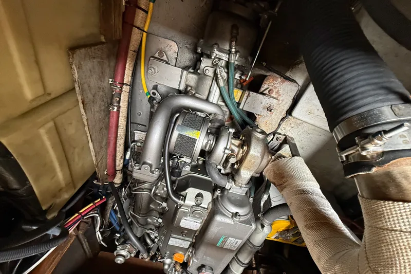 Slide: The Image of Engine compartment of a 1974 Spencer 53, showcasing mechanical components and wiring. - 32