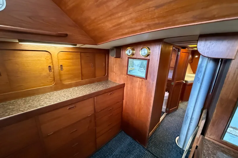 Slide: The Image of Interior of a 1974 Spencer 53 yacht with wooden cabinetry and nautical decor. - 16