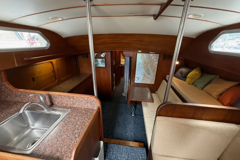 Slide: The Image of Interior of a 1974 Spencer 53 sailboat with wood finish and cozy seating area. - 7