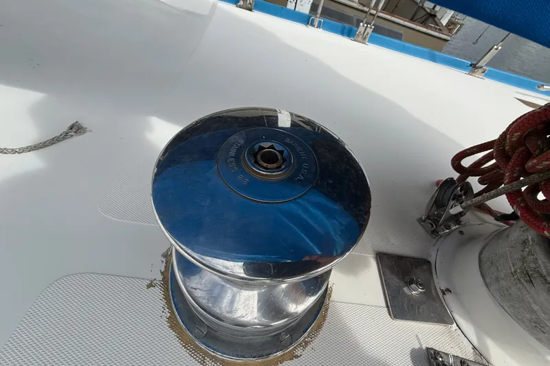 Slide: The Image of Chrome winch on 1974 Spencer 53 sailboat deck with red ropes. - 46