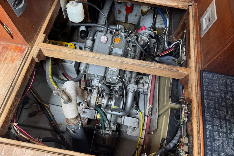 Slide: The Image of Engine compartment of a 1974 Spencer 53 boat, showcasing mechanical components and wiring. - 33