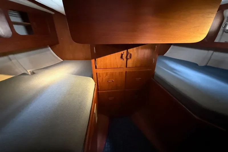 Slide: The Image of Interior of a 1974 Spencer 53 yacht with wooden cabinetry and twin beds. - 27