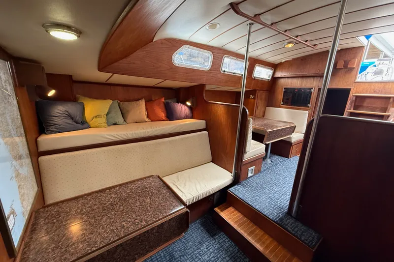 Slide: The Image of Interior of a 1974 Spencer 53 yacht with cozy seating and wooden finishes. - 17
