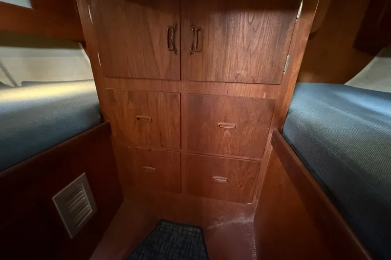 Slide: The Image of Wooden cabin interior with storage drawers in a 1974 Spencer 53 boat. - 37