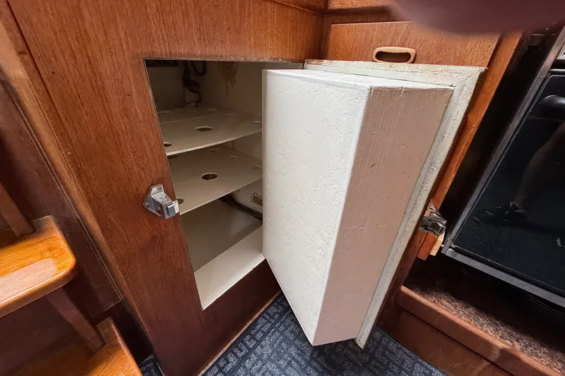 Slide: The Image of Wooden cabinet with open door revealing shelves, Spencer 53, 1974 model. - 35