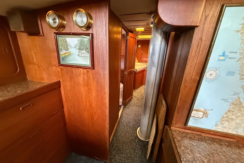 Slide: The Image of Wood-paneled interior of a 1974 Spencer 53 yacht with nautical decor and map. - 18