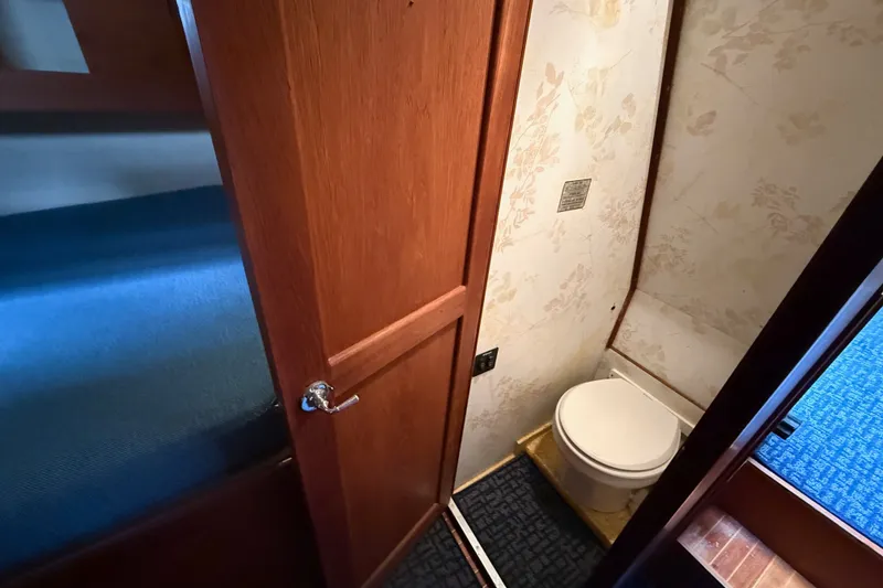 Slide: The Image of 1974 Spencer 53 yacht bathroom with wooden door and floral wallpaper. - 31