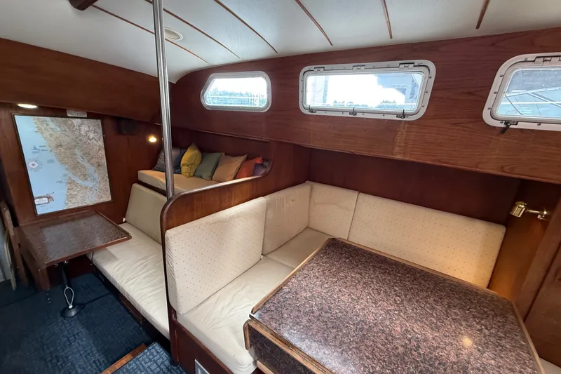 Slide: The Image of Interior of a 1974 Spencer 53 sailboat with cozy seating and nautical decor. - 13