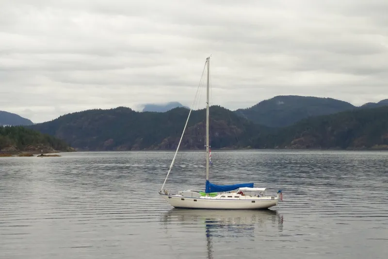 Slide: The Image of Sailboat on calm water with mountainous backdrop, Spencer 53 model, 1974. - 68