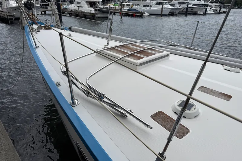 Slide: The Image of 1974 Spencer 53 sailboat docked at marina, showcasing deck and rigging. - 64