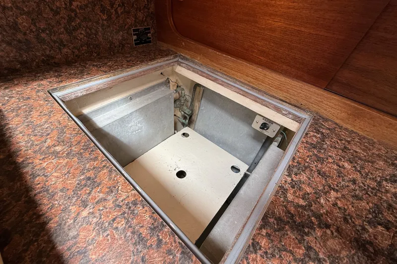 Slide: The Image of Hidden compartment in a 1974 Spencer 53 boat with wood and patterned surfaces. - 34
