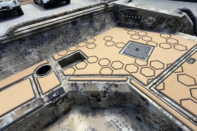 Slide: The Image of 2027 Excel 183 Tomahawk boat interior with hexagonal pattern flooring and camouflage design. - 24