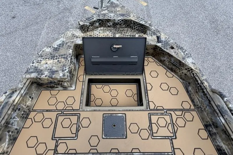 Slide: The Image of 2027 Excel 183 Tomahawk boat deck with hexagonal pattern and open storage compartment. - 16
