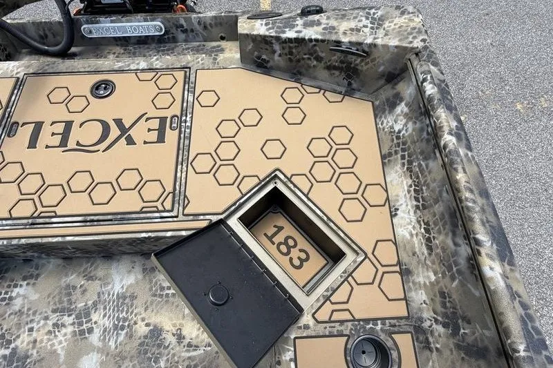 Slide: The Image of 2027 Excel 183 Tomahawk boat interior with hexagonal pattern and storage compartment. - 26