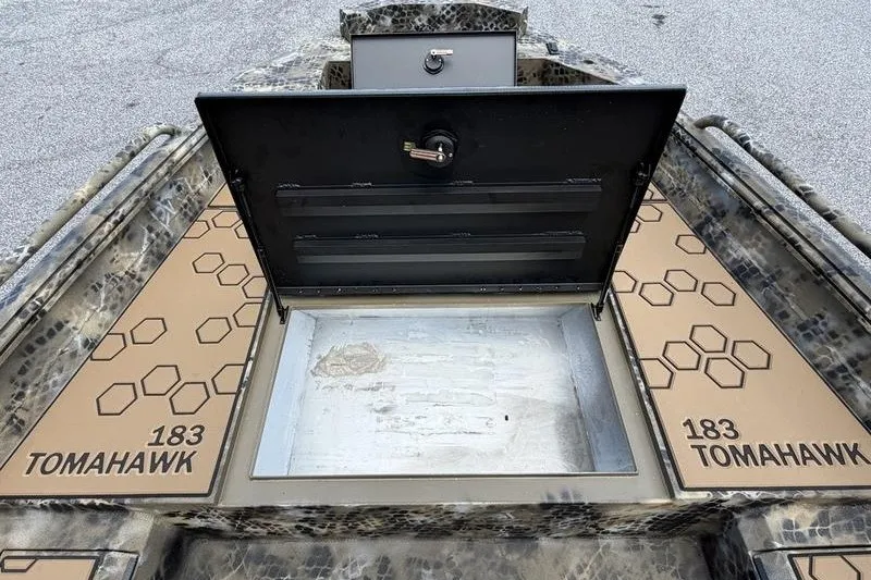 Slide: The Image of Open storage compartment on 2027 Excel 183 Tomahawk boat with hexagonal design. - 17