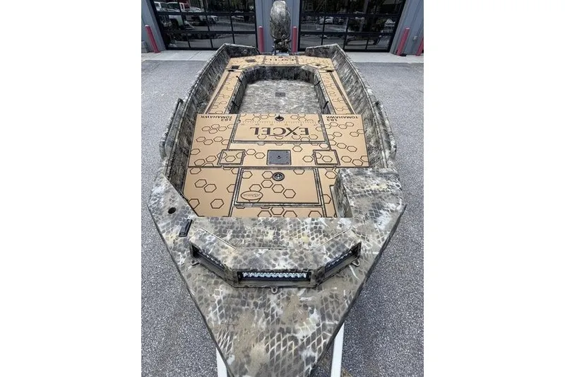 Slide: The Image of 2027 Excel 183 Tomahawk boat with camouflage design and spacious deck layout. - 18