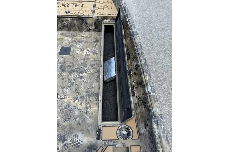 Slide: The Image of 2027 Excel 183 Tomahawk boat interior with camouflage design and storage compartment. - 19