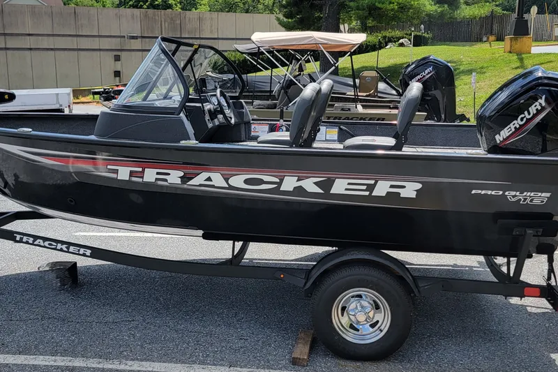 The Image of 2026 Tracker Pro Guide V-16 WT boat on trailer, featuring Mercury engine. - 0