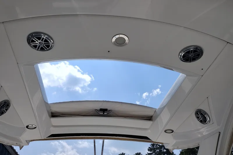 Slide: The Image of 2020 Formula 350 Crossover Bowrider sunroof with speakers and blue sky view. - 53