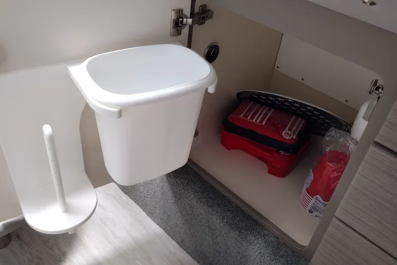 Slide: The Image of Interior storage of 2020 Formula 350 Crossover Bowrider with trash bin and emergency kit. - 48