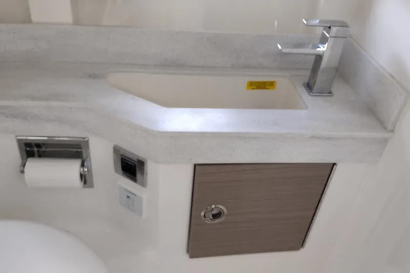 Slide: The Image of 2020 Formula 350 Crossover Bowrider bathroom sink with modern faucet and storage cabinet. - 42
