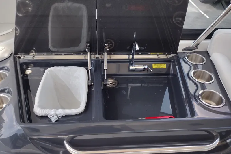 Slide: The Image of 2020 Formula 350 Crossover Bowrider sink area with trash bin and cup holders. - 28