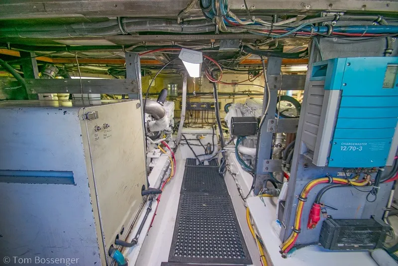 Slide: The Image of Engine room of 1987 Hatteras 52 Convertible yacht, showcasing machinery and wiring. - 59