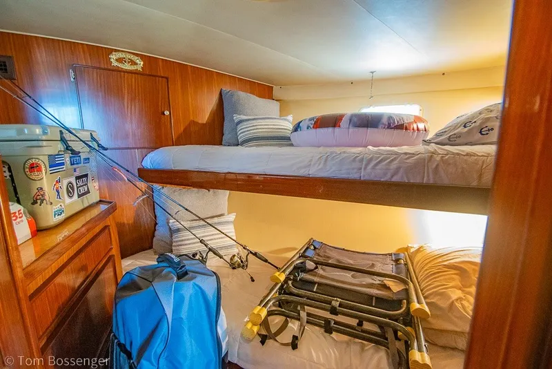 Slide: The Image of Cozy cabin interior of 1987 Hatteras 52 Convertible with bunk beds and fishing gear. - 31