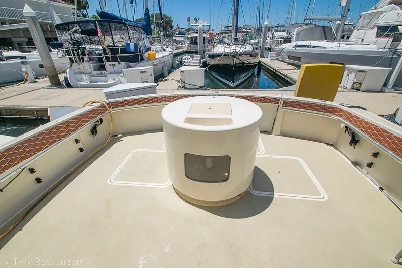 Slide: The Image of 1987 Hatteras 52 Convertible yacht deck at marina, surrounded by boats. - 38