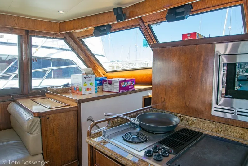 Slide: The Image of Interior of 1987 Hatteras 52 Convertible yacht kitchen with stove and window view. - 18