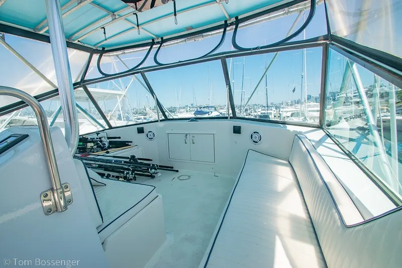 Slide: The Image of Interior view of 1987 Hatteras 52 Convertible yacht with fishing rods and seating. - 48