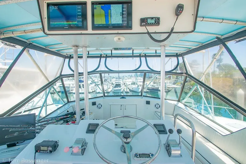 Slide: The Image of Cockpit view of a 1987 Hatteras 52 Convertible yacht with navigation equipment. - 46