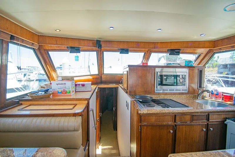 Slide: The Image of Interior of 1987 Hatteras 52 Convertible yacht with kitchen and seating area. - 19