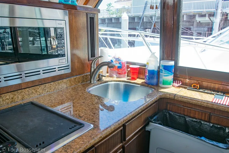 Slide: The Image of Interior of 1987 Hatteras 52 Convertible yacht kitchen with sink and microwave. - 17