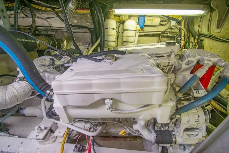 Slide: The Image of Engine room of a 1987 Hatteras 52 Convertible yacht, showcasing mechanical components. - 64
