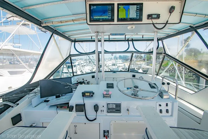 Slide: The Image of Cockpit of 1987 Hatteras 52 Convertible yacht with navigation equipment and steering wheel. - 42
