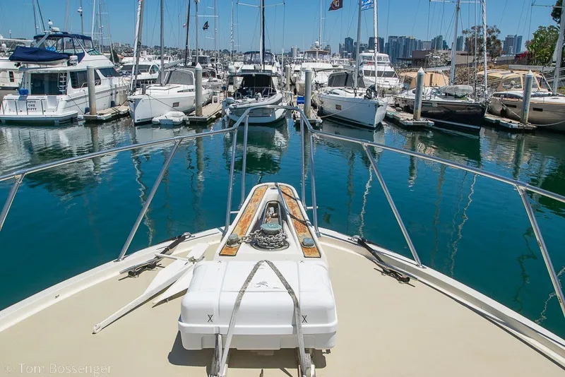 Slide: The Image of Bow view of 1987 Hatteras 52 Convertible yacht docked in a marina. - 55