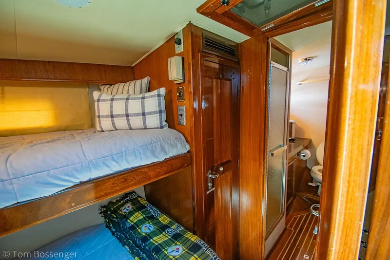 Slide: The Image of Interior of 1987 Hatteras 52 Convertible yacht with wooden bunk beds and bathroom. - 29