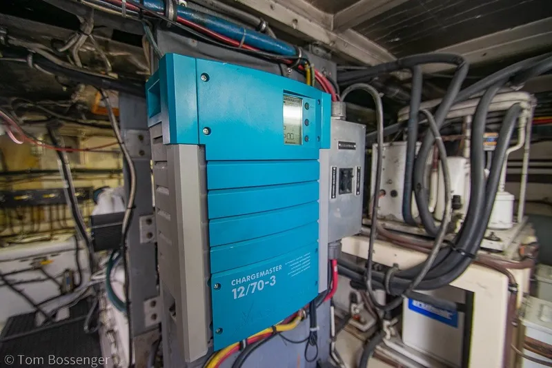 Slide: The Image of Engine room of 1987 Hatteras 52 Convertible with blue battery charger and wiring. - 69