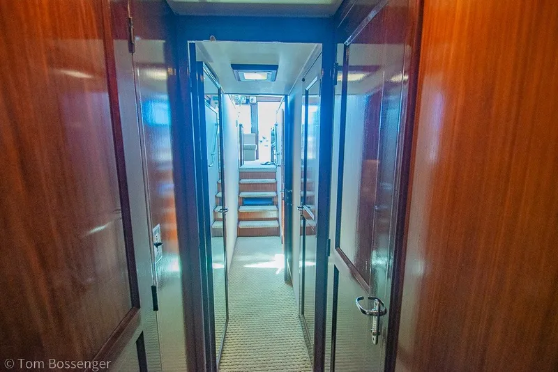 Slide: The Image of Interior hallway of a 1987 Hatteras 52 Convertible yacht with wooden paneling. - 33